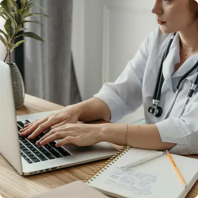 Doctor typing on laptop