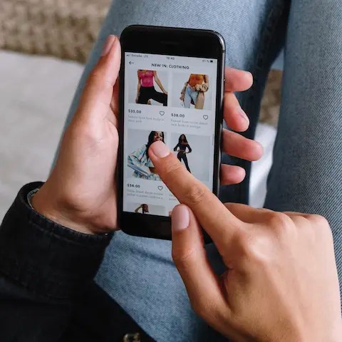 Hand swiping through an ecommerce store on their smartphone