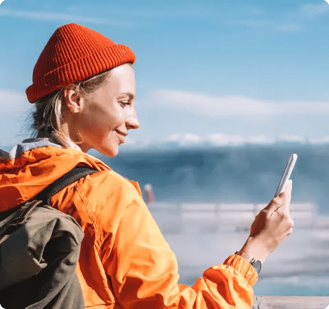 Female traveler looking at her mobile phone