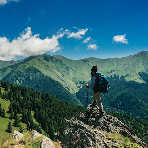 Photo of a traveller on a mountain top