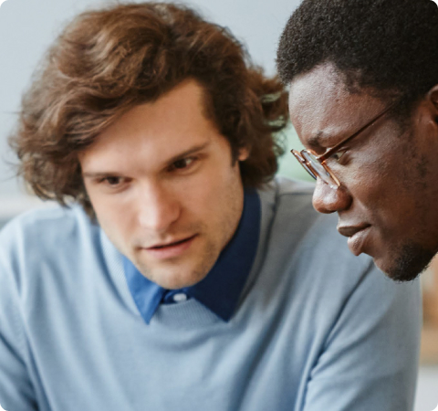 Faces of two men looking at something out of frame