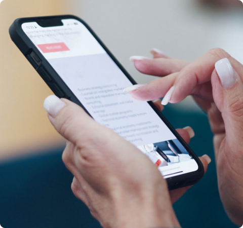 Photo of a person's hands scrolling on a mobile phone