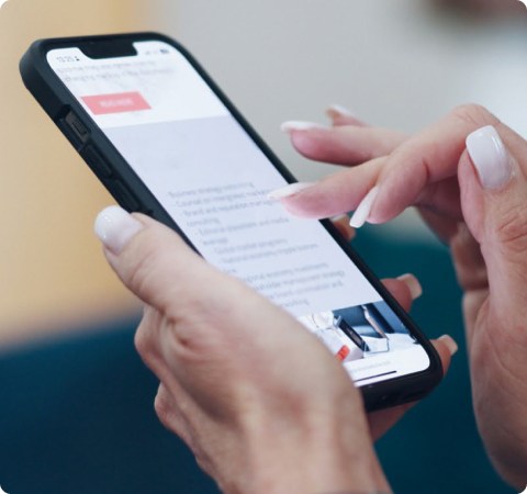 Photo of a person's hands scrolling on a mobile phone