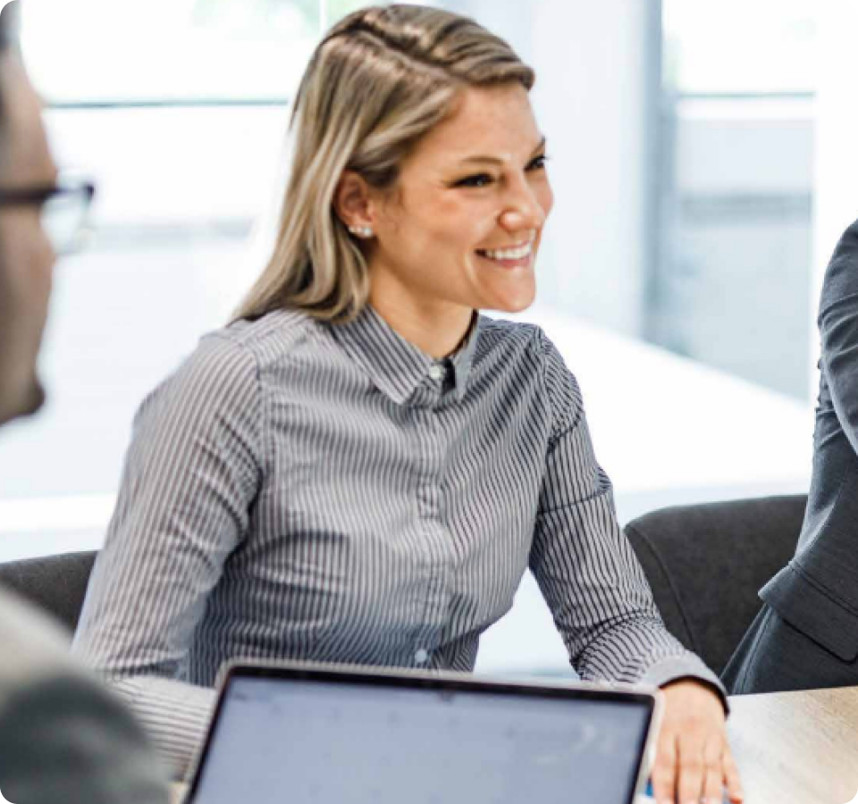 image of a business woman smiling during a meeting