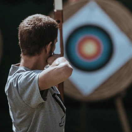 Man shooting an arrow at a bullseye